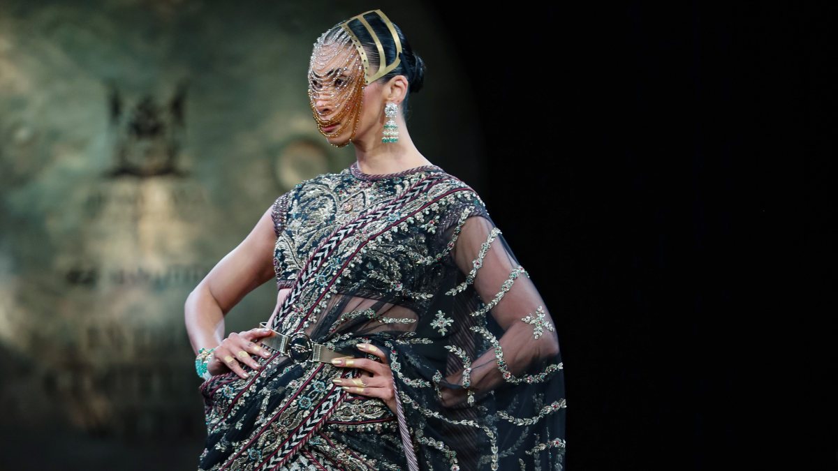A model walks on the ramp during Day 2 of India Couture Week to showcase…
