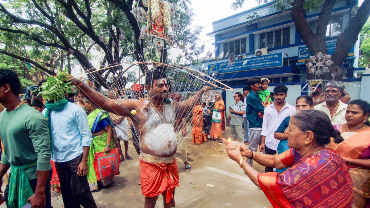 Devotees carry lit kavadi in Chennai Aadi festival procession