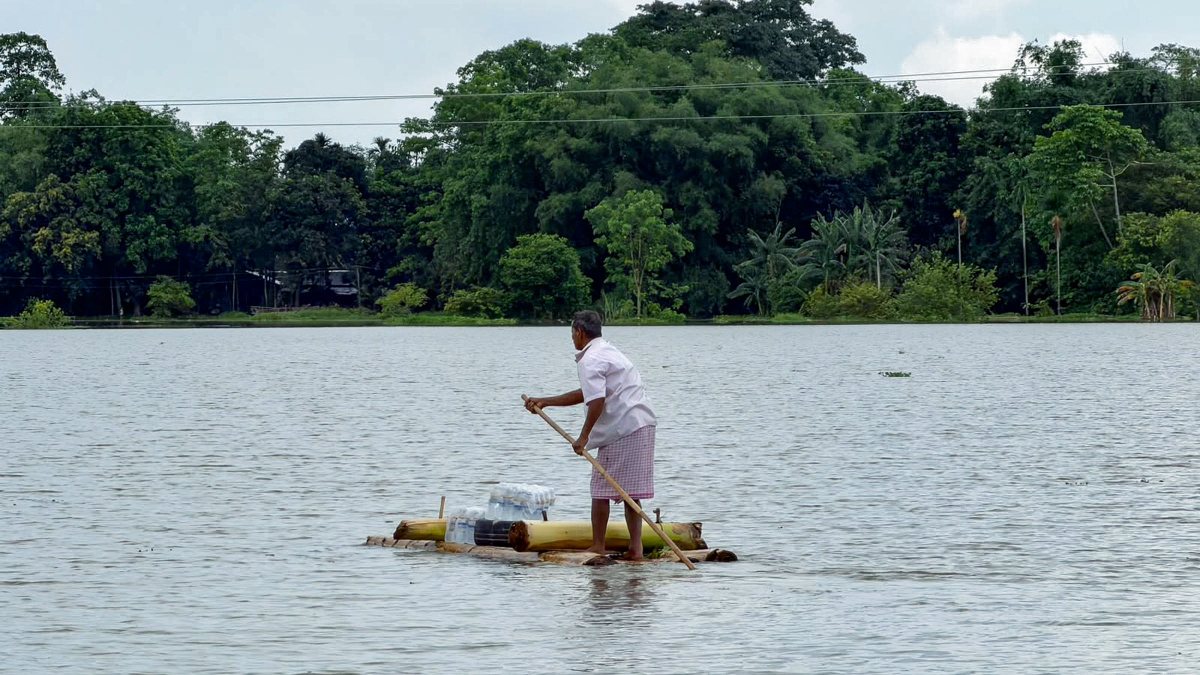 Man carries essentials on makeshift raft in flood-hit Sivasagar