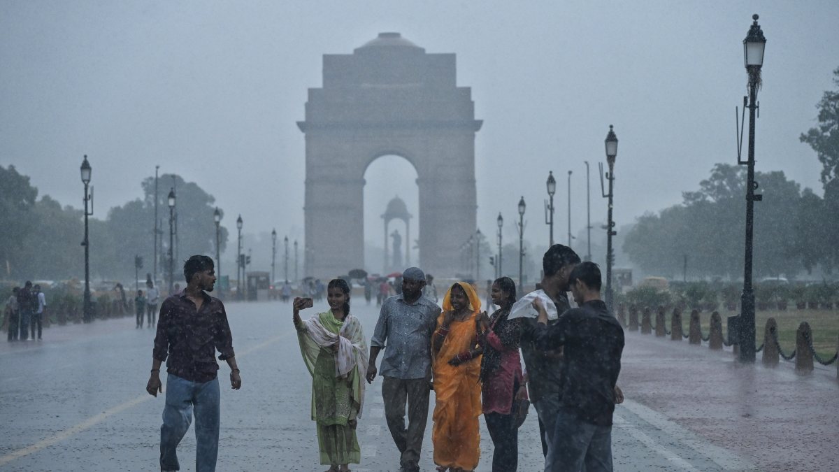 Visitors enjoy monsoon showers at Kartavya Path in Delhi