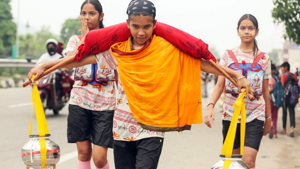 Young girl carries Ganga water during Kanwar Yatra in Haridwar