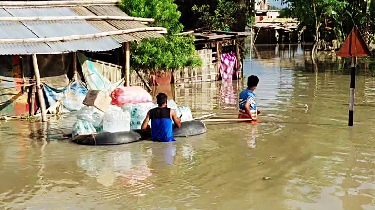 Flood-hit residents use makeshift raft to move belongings in Sivasagar