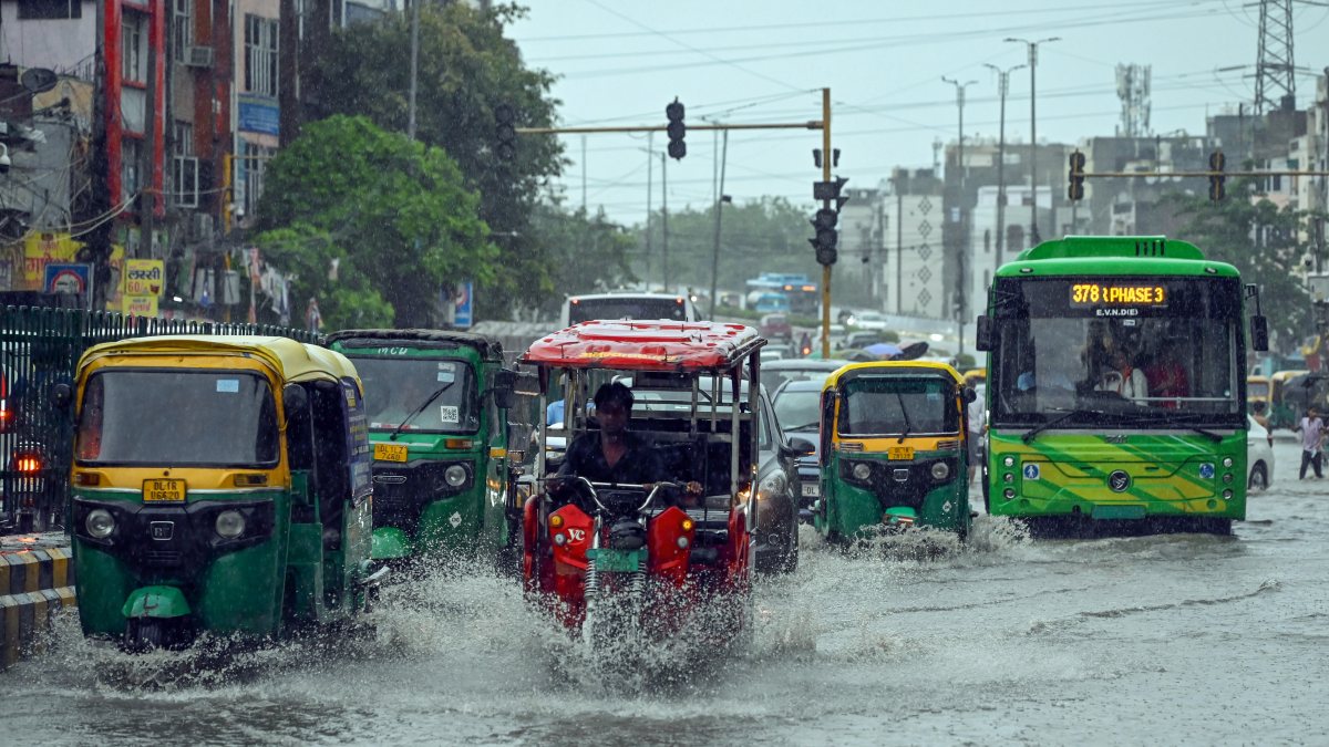 Commuters wade through waterlogged Delhi road amid heavy monsoon rains