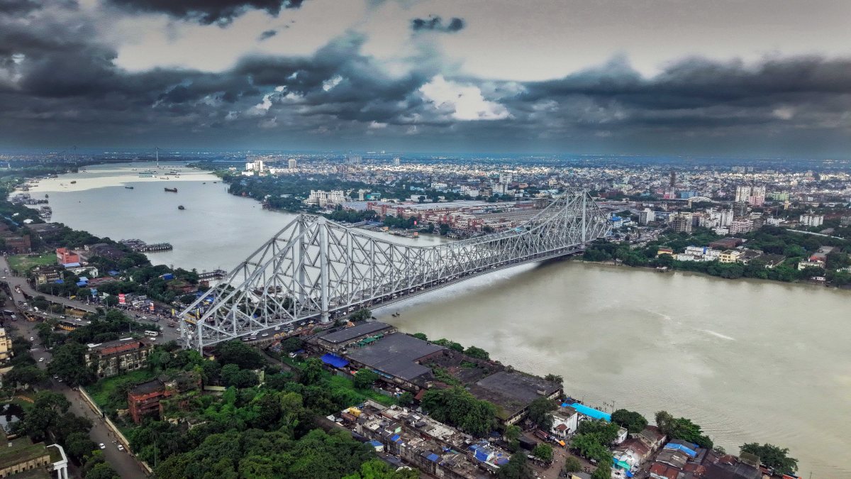 Aerial view of Howrah Bridge under dark clouds in Kolkata