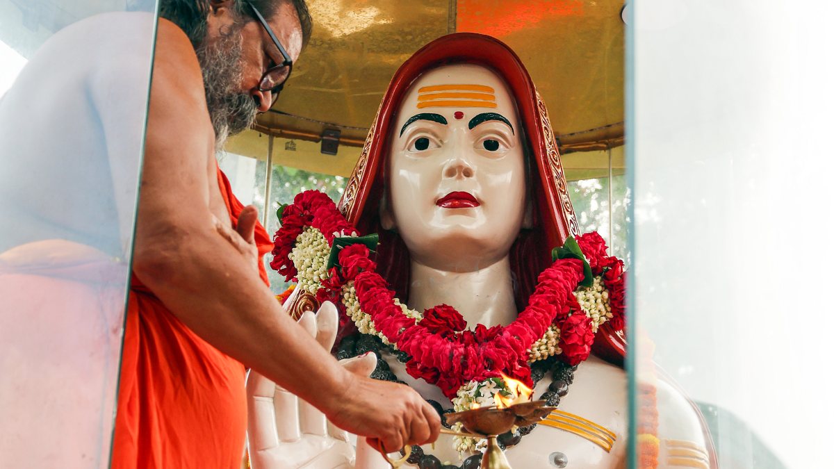 Saint performs Aarti before Adi Shankaracharya statue on Guru Purnima