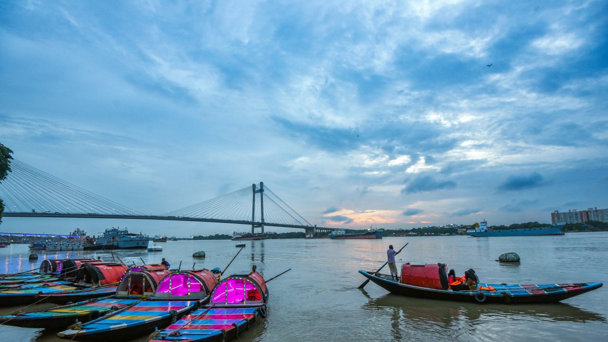 Boatmen wait for tourists on the Ganges amid Kolkata monsoon