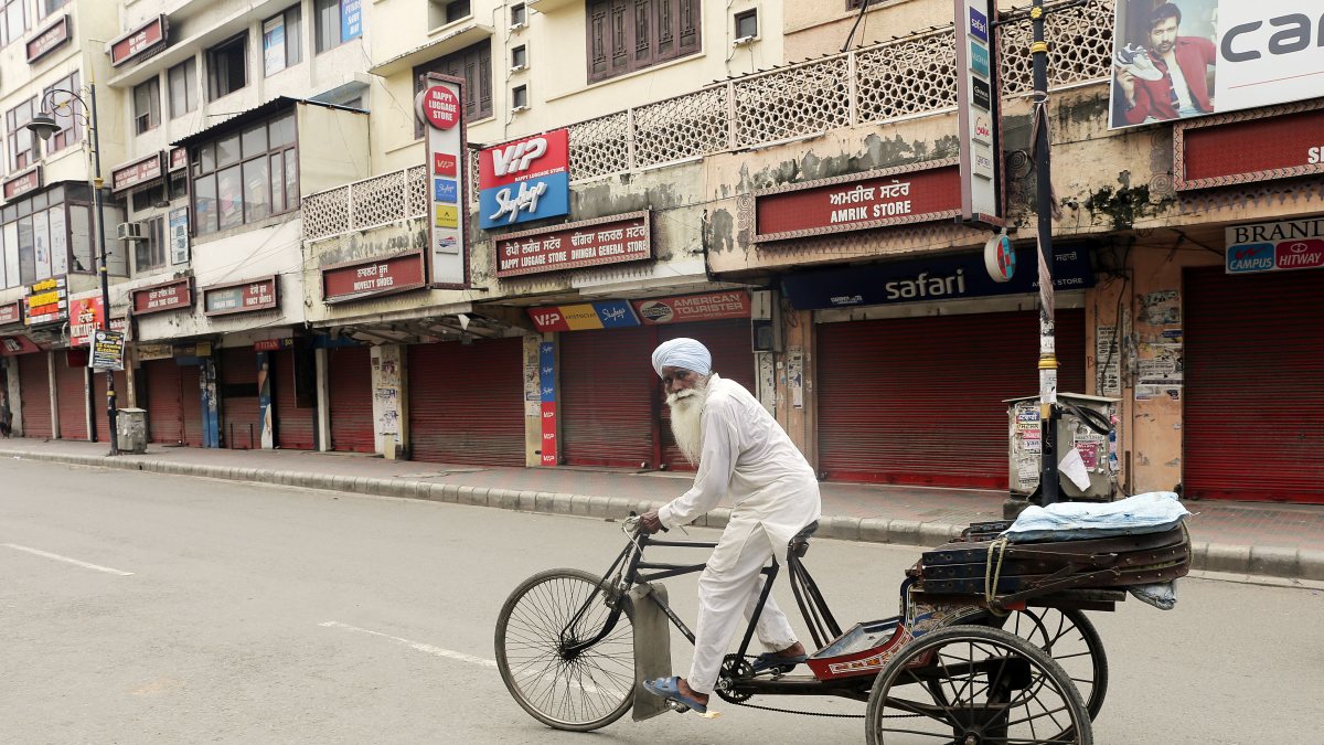 Rickshawpuller on deserted road during Punjab Bandh protest