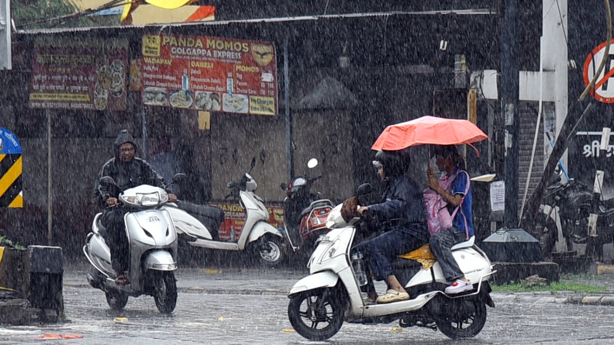Nagpur commuters brave heavy rain in raincoats