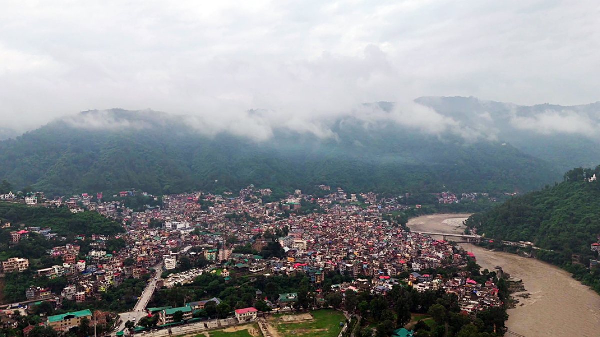 Aerial view of Mandi town along Beas River amid cloudy weather