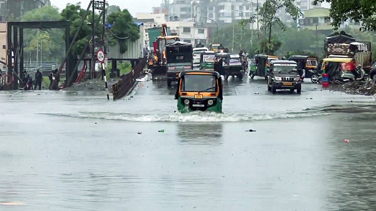 Heavy rains flood Surat streets, vehicles wade through water