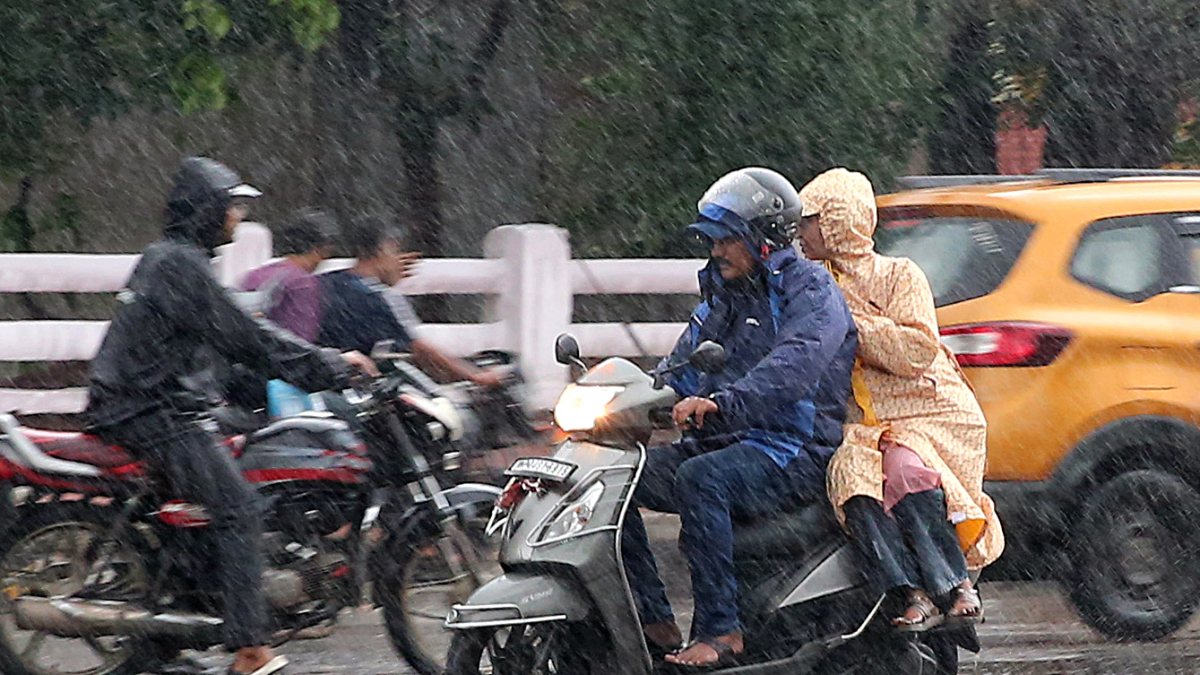 Bhopal commuters navigate rain-slicked roads amid downpour