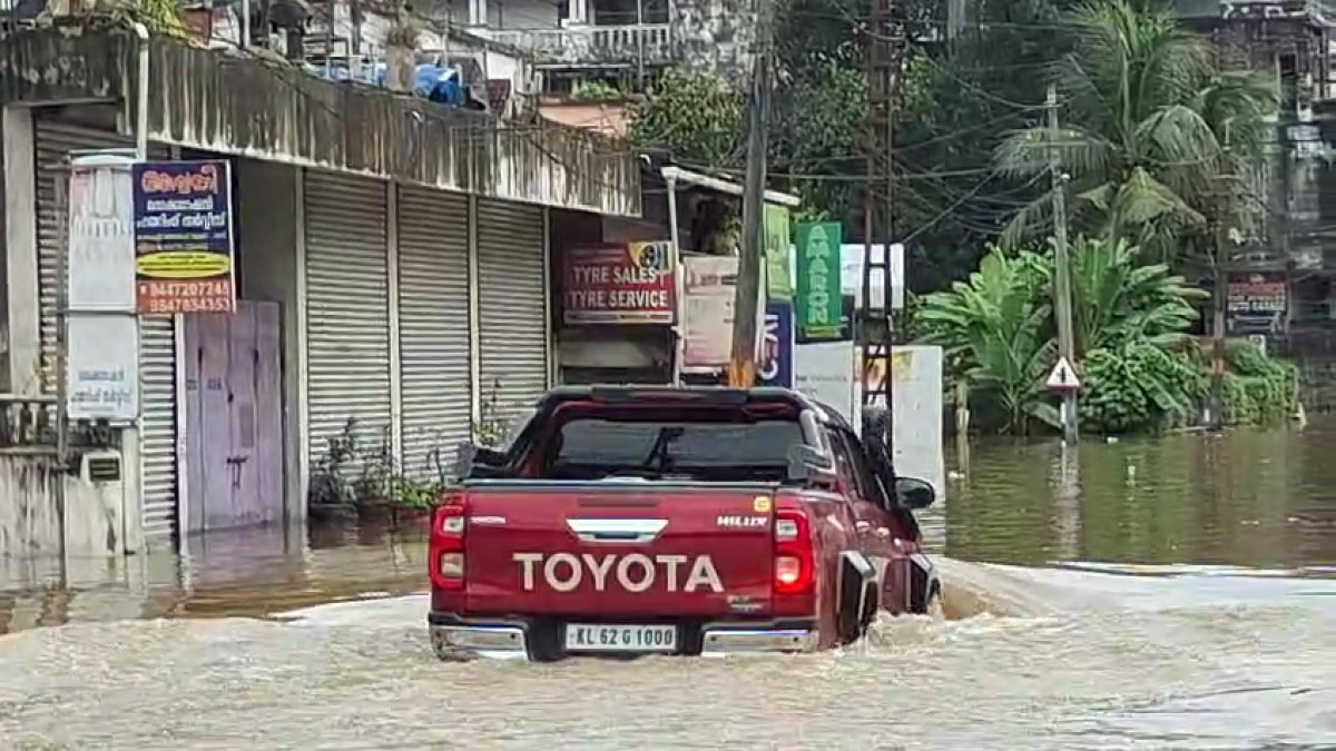 Kerala floods: commuter wades through inundated Ranni