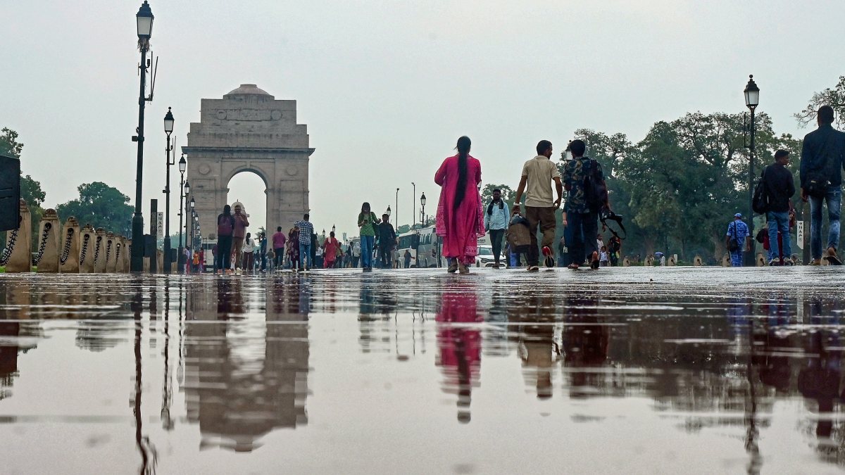 Rain-soaked road mirrors India Gate after Delhi showers