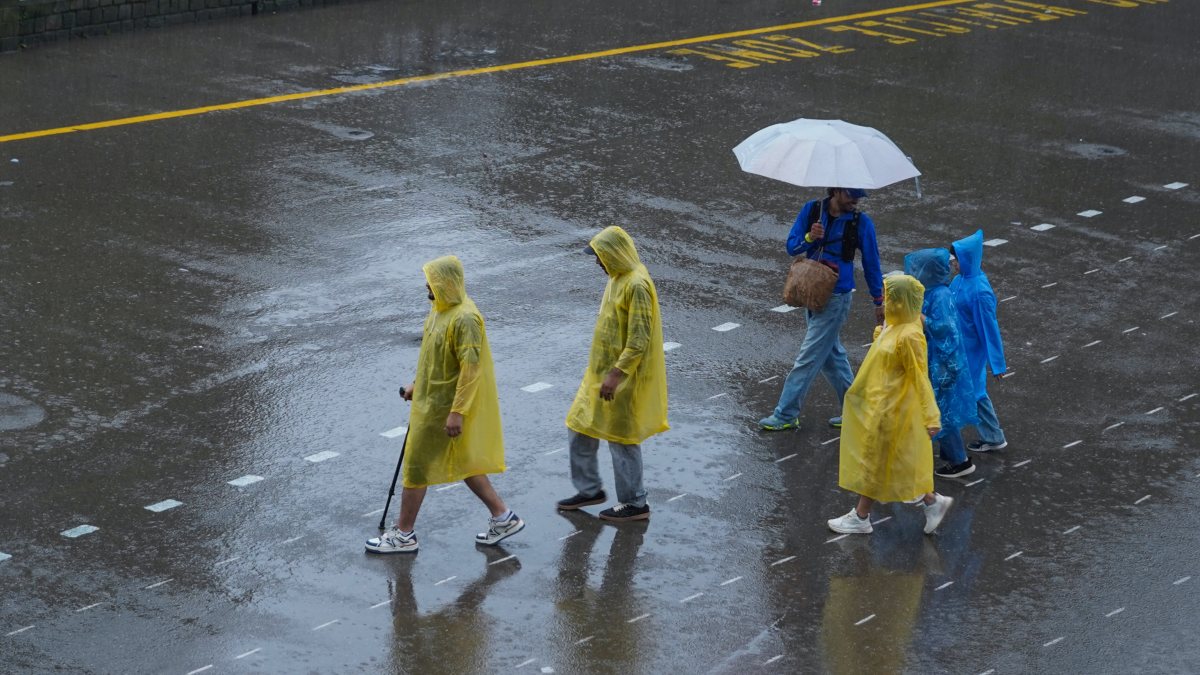 Shimla residents brave heavy rainfall in raincoats