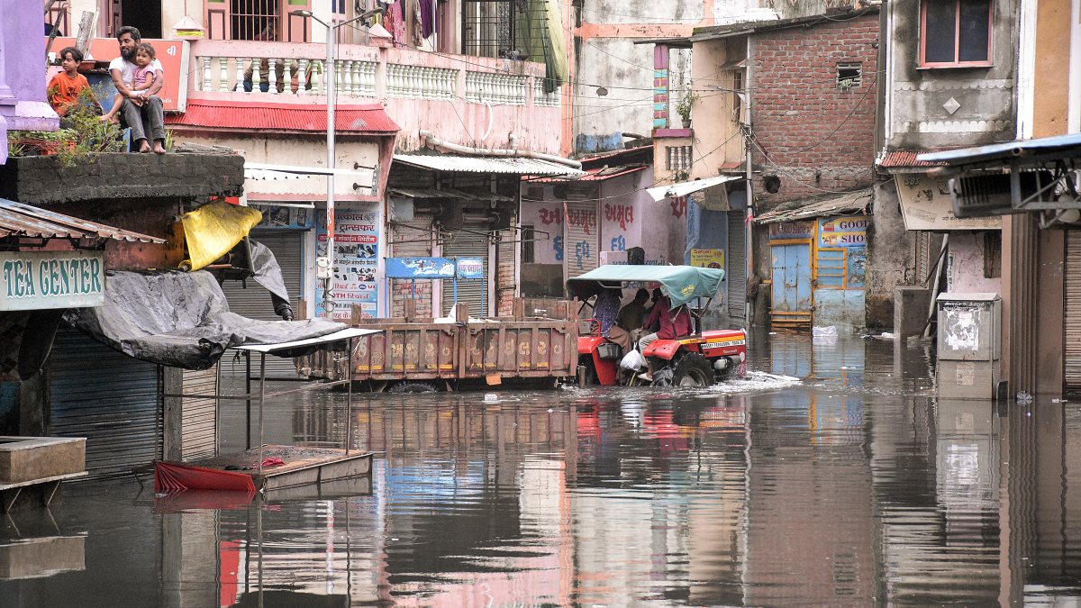 Heavy rains submerge Surat roads, tractor wades through water