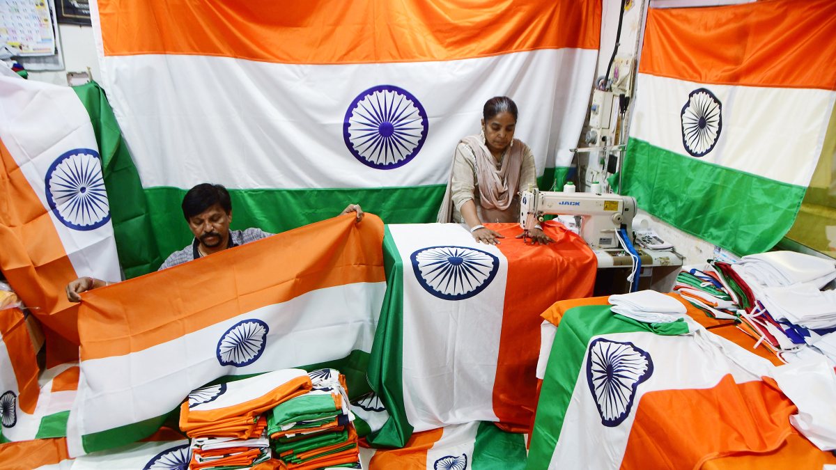 Workers put final touches to tricolour at Mumbai flag factory