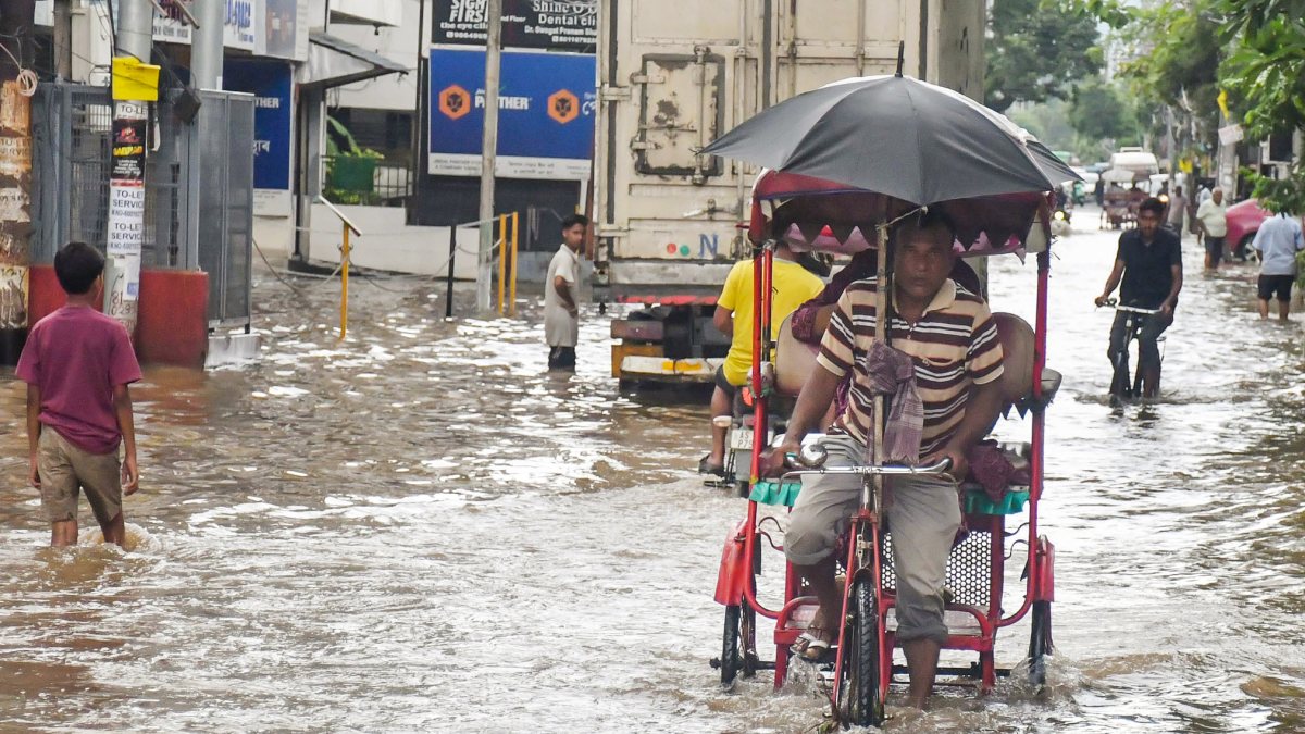 Guwahati commuters wade through waterlogged Rajgarh Road after heavy rain
