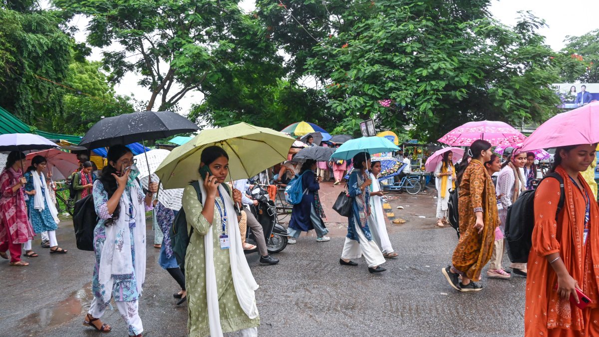 Monsoon rains drench Patna as students shield with umbrellas