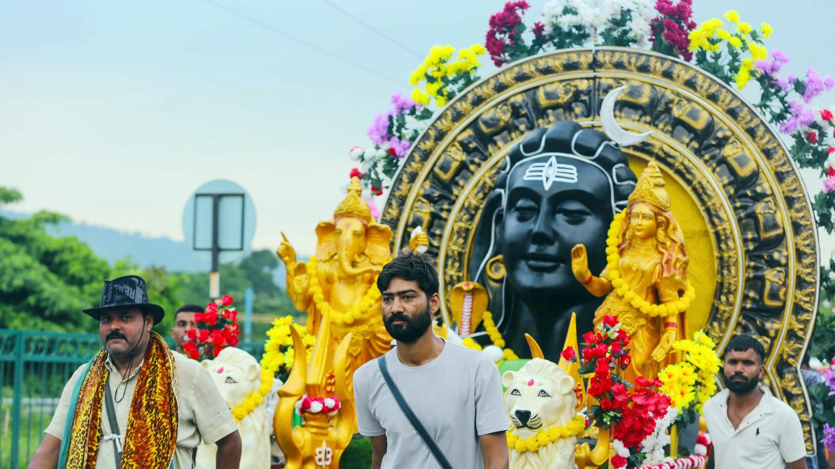 Devotees carry decorated kanwar during Sawan yatra in Haridwar