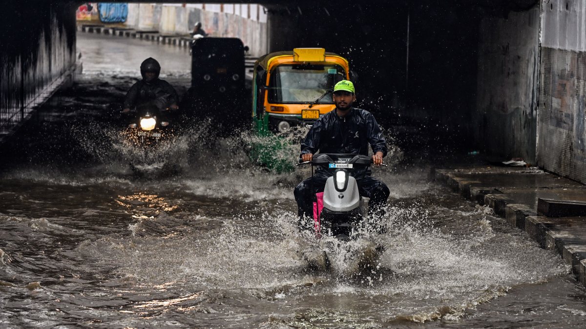 Delhi commuters wade through waterlogged Lajpat Nagar underpass
