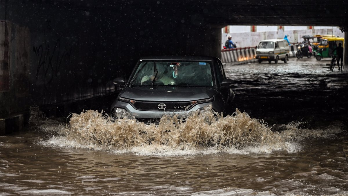 Commuters wade through waterlogged Lajpat Nagar underpass after heavy rain