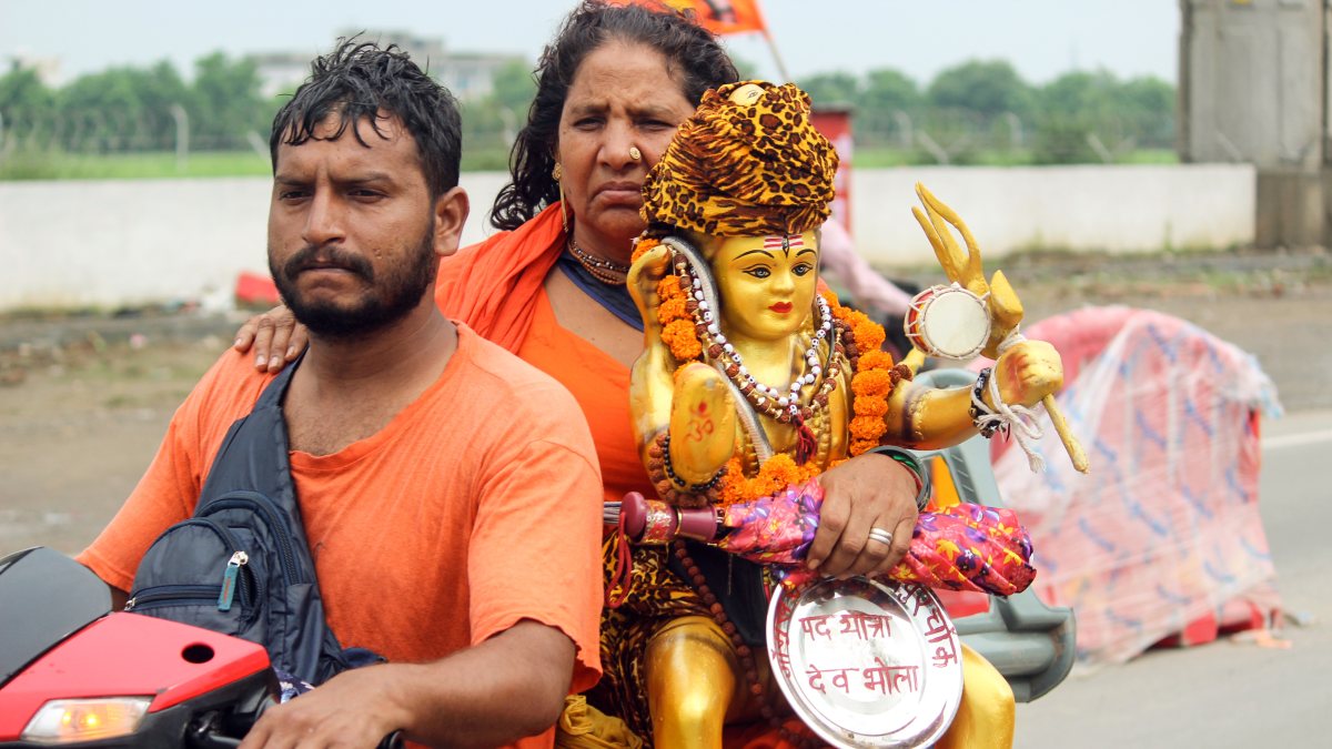 Woman devotee carries Lord Shiva idol during Kanwar Yatra in Meerut