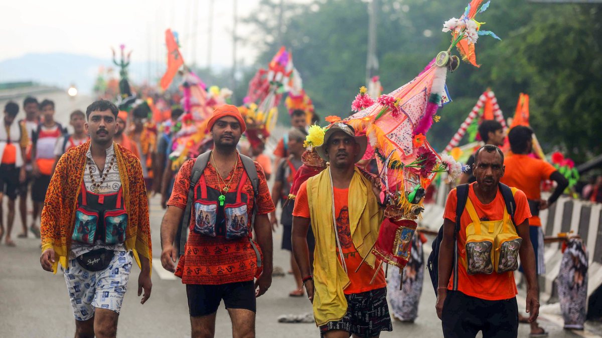 Devotees carry Ganga Jal during Kanwar Yatra amid heavy rain in Haridwar