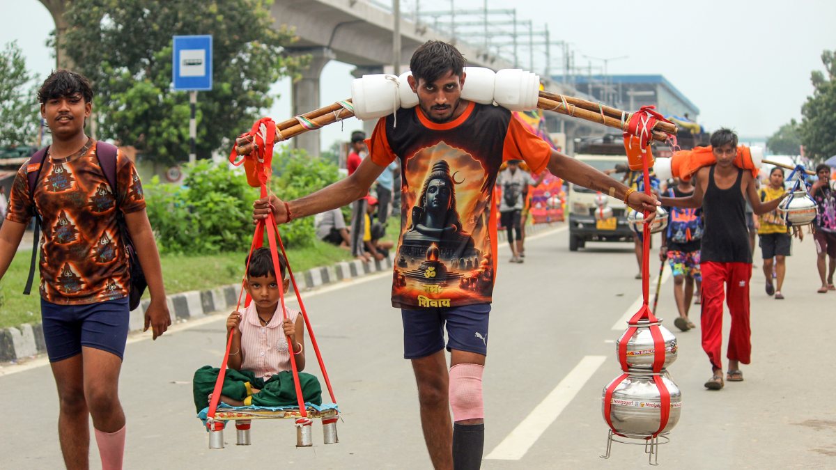 Devotees carry Gangajal pots during Kanwar Yatra in Meerut
