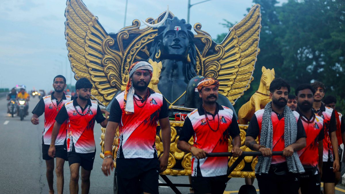 Devotees carry Dandi Kanwar during Kanwar Yatra in Haridwar
