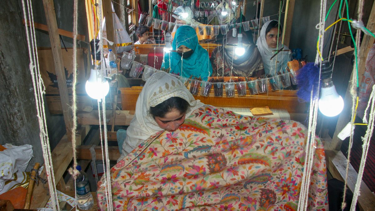 Women weave Pashmina shawls on National Handloom Day in Anantnag