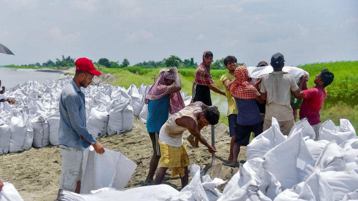 Assam workers prepare geo bags to curb Brahmaputra erosion