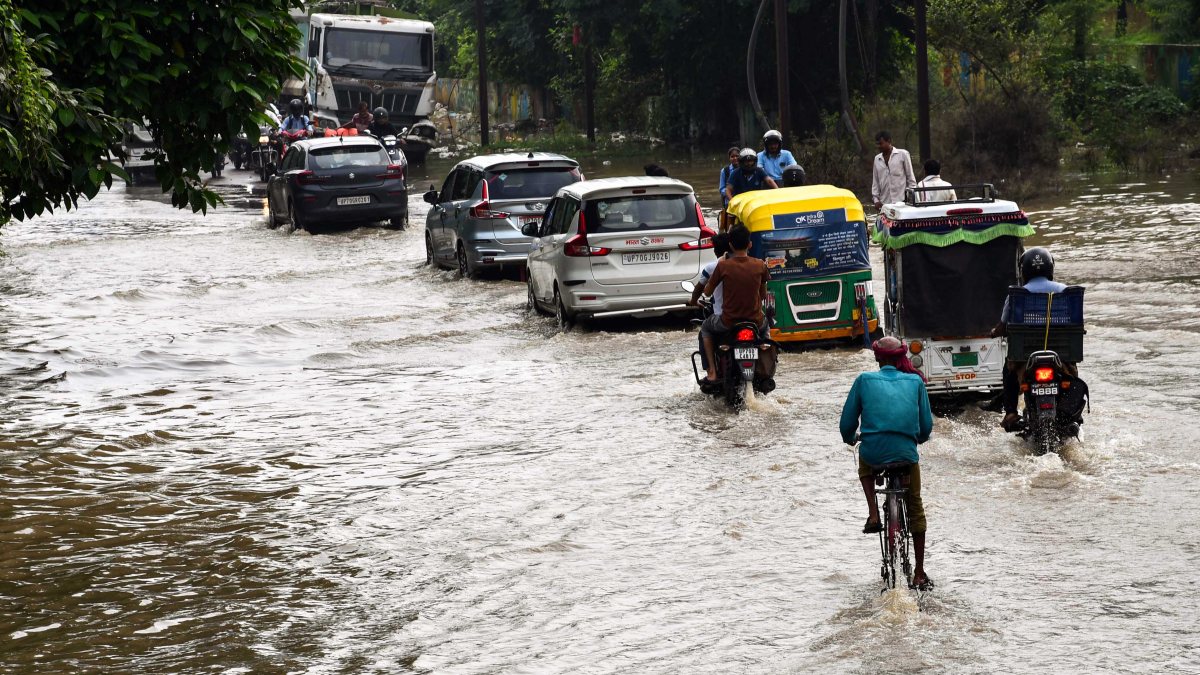 Commuters wade through waterlogged Prayagraj road amid heavy rain