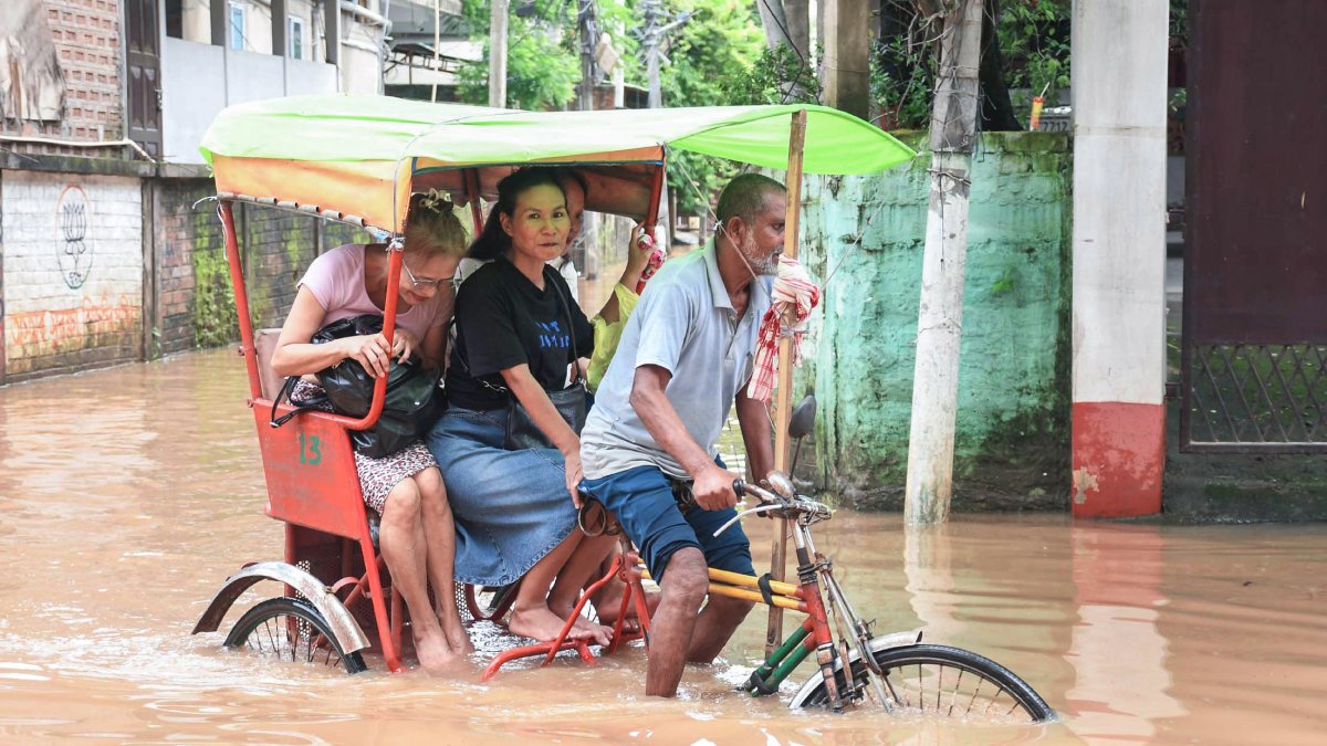 Rickshaw pulls through waterlogged Guwahati street after heavy rain