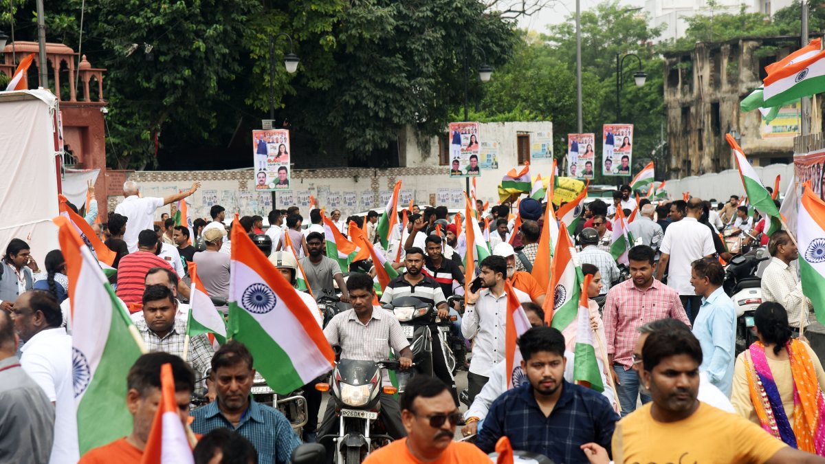 People with flags in their hands participate in a Tiranga Yatra as part of the…