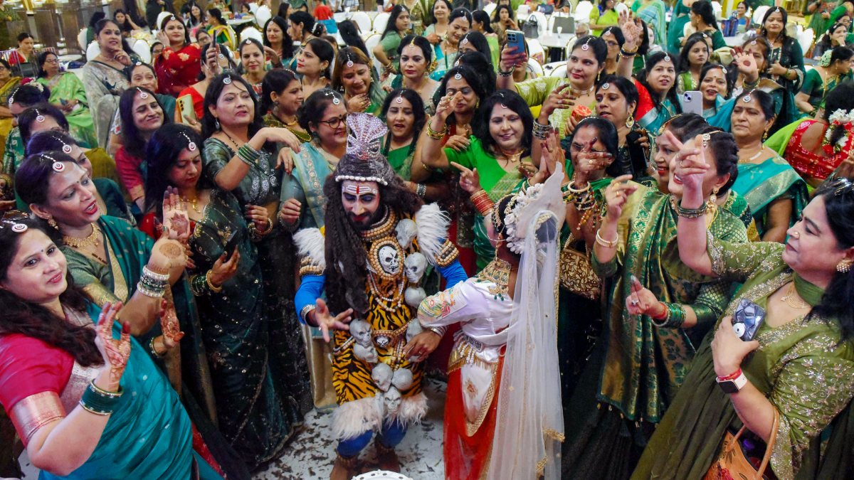 Artists perform as Shiva-Parvati at Sawan Milan in Patna
