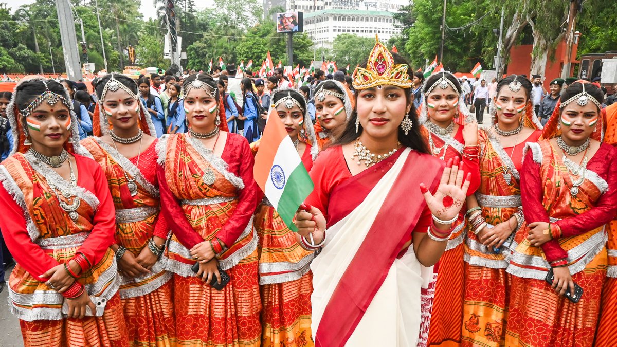 A girl dressed as Bharat Mata, along with others in traditional attire, takes…