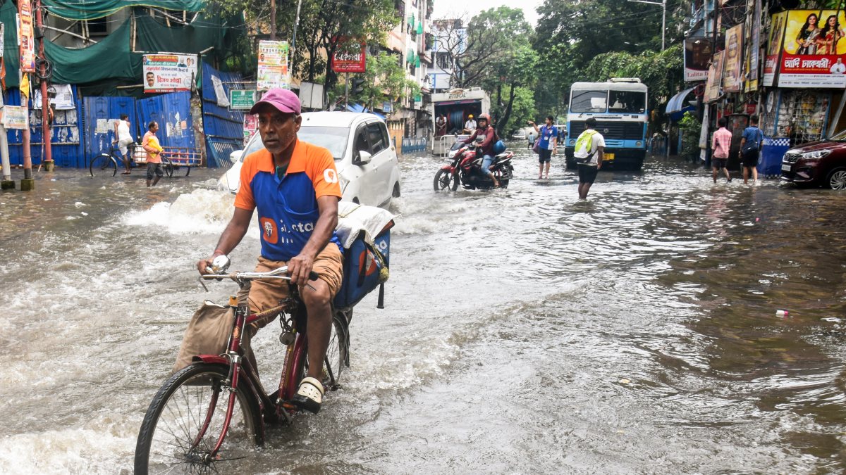 Kolkata commuters wade through waterlogged streets after rain