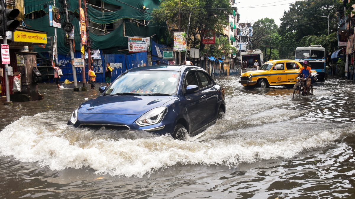 Kolkata commuters wade through waterlogged streets after heavy rain