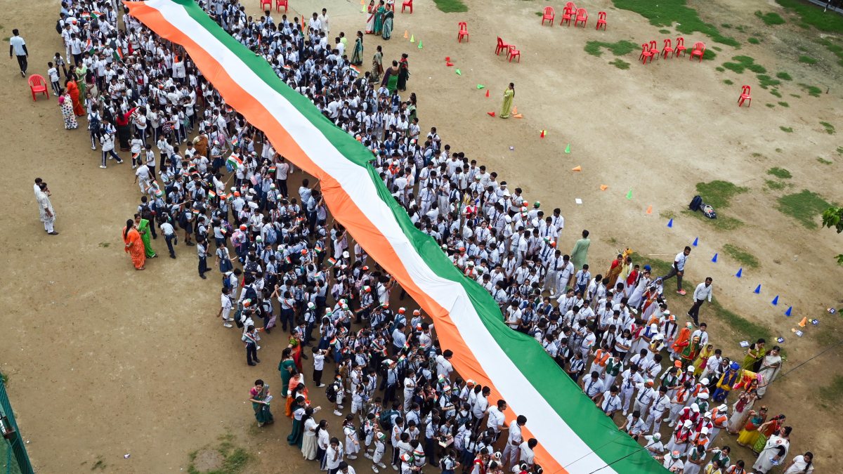 Students march with 100-foot flag ahead of Independence Day