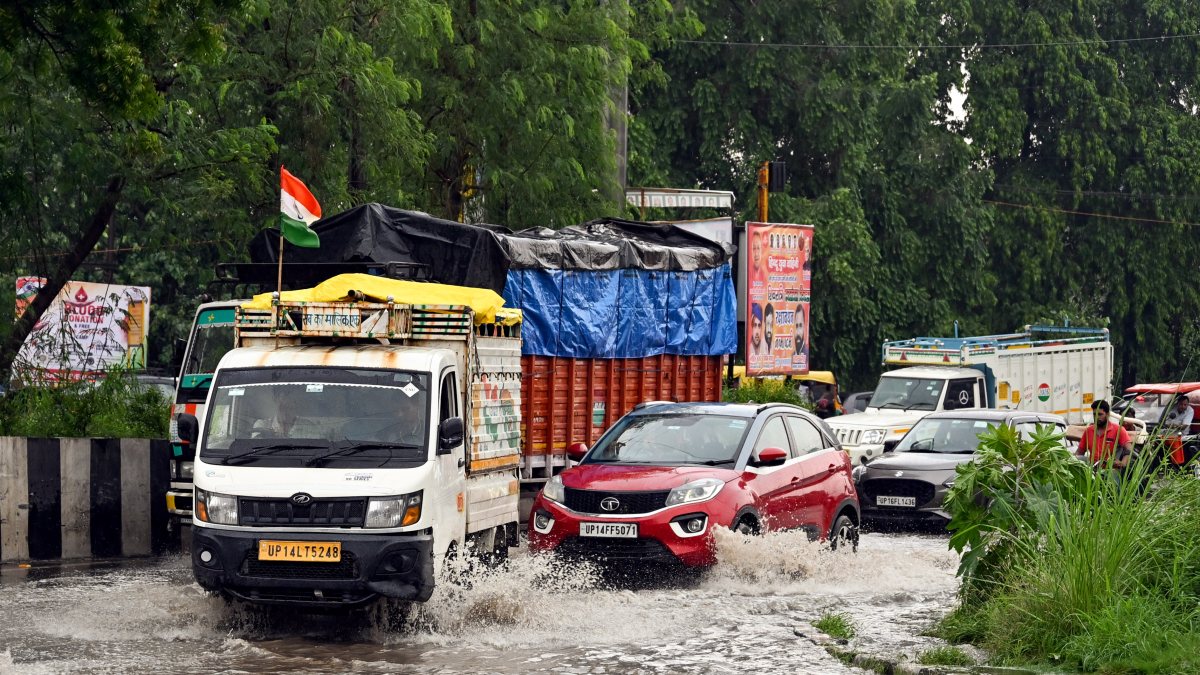 Commuters wade through waterlogged NH-24 after rain in Ghaziabad