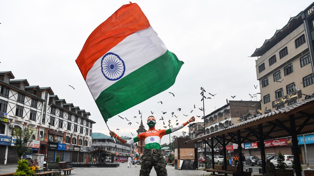 Man in tricolour paint waves flag at Srinagar's Lal Chowk