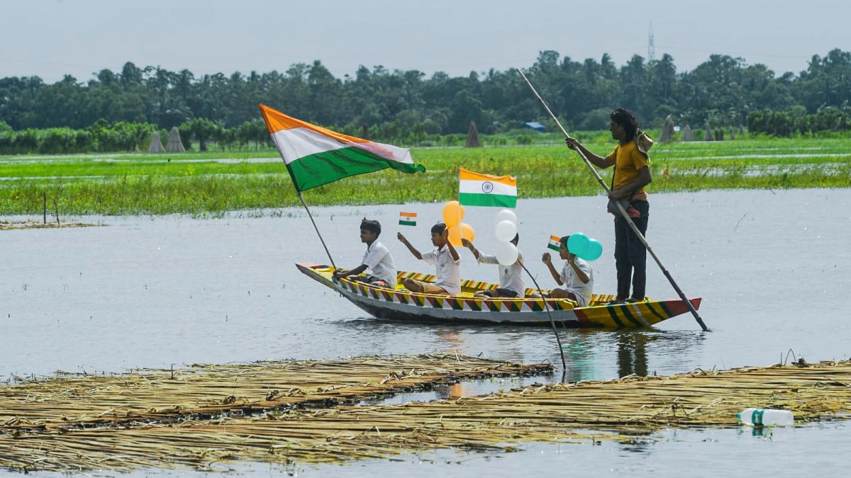 Children row boat with tricolour balloons on Independence Day