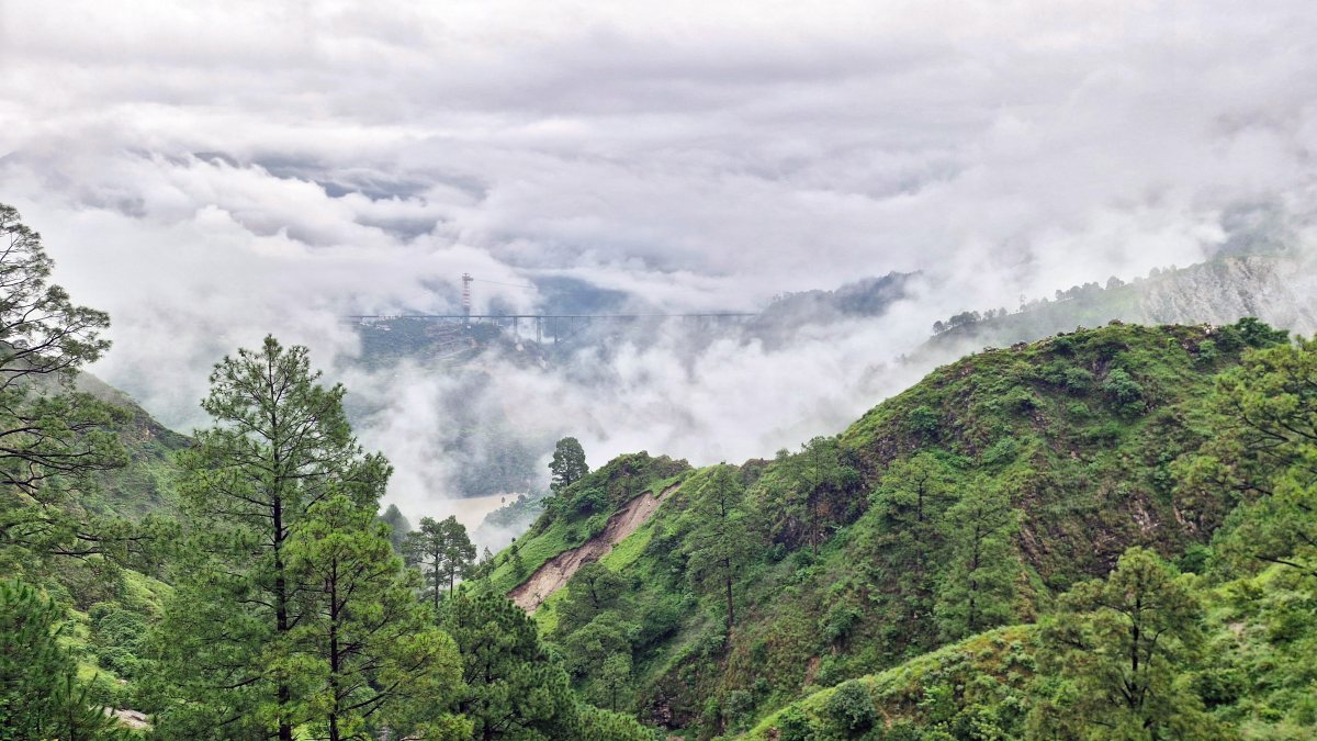 Chenab Railway Bridge shrouded in clouds in Reasi