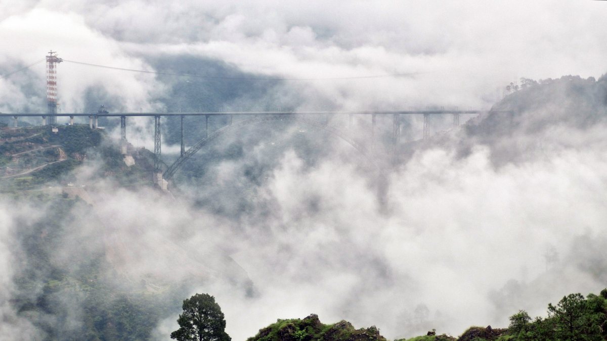 Chenab Railway Bridge shrouded in thick clouds in Reasi