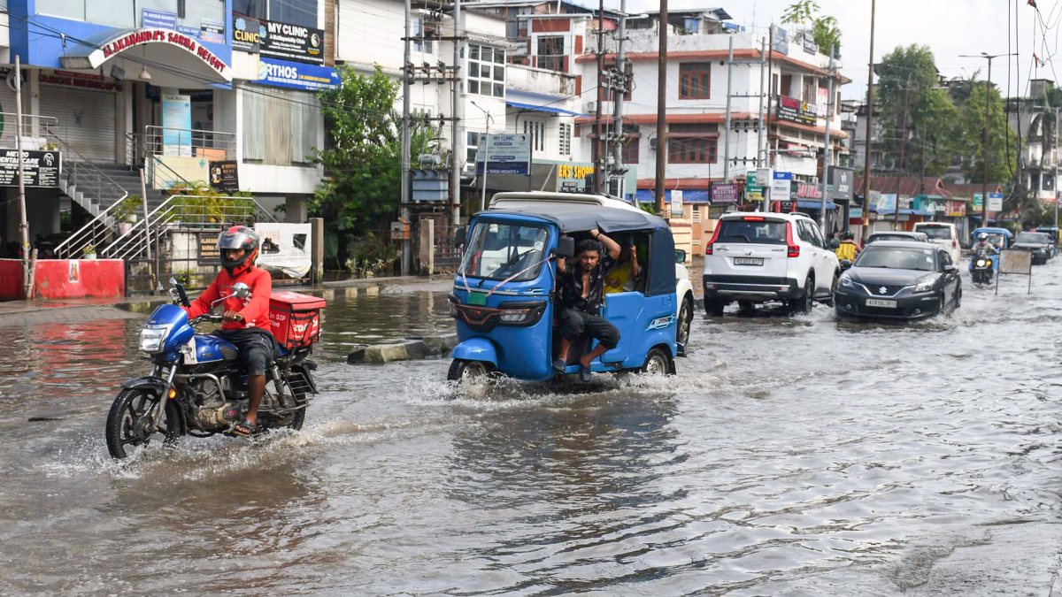 Guwahati commuters wade through waterlogged road after heavy rain
