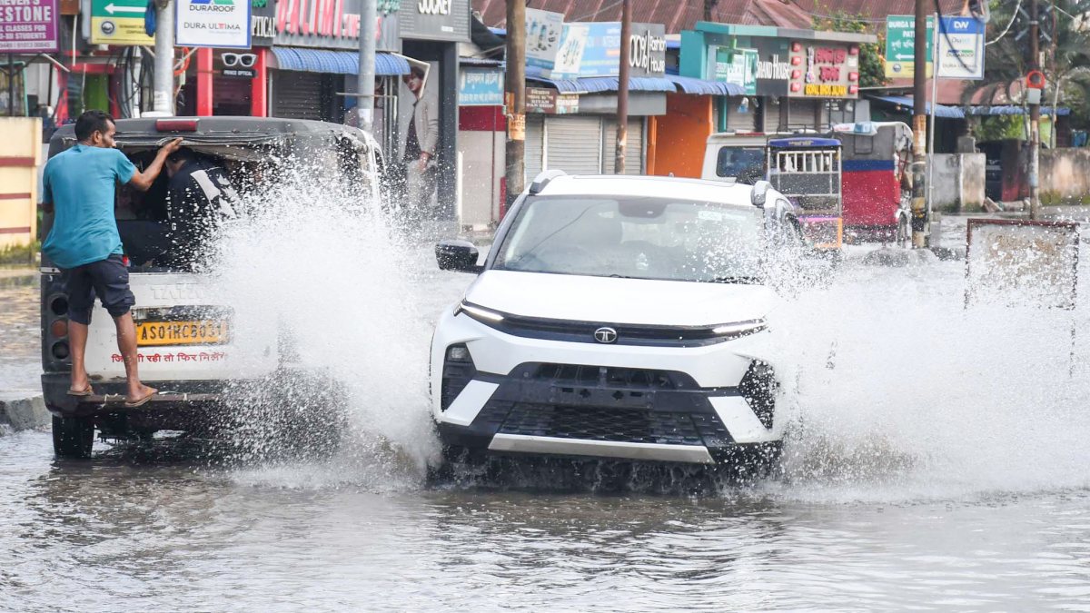 Guwahati commuters wade through waterlogged road after heavy rain