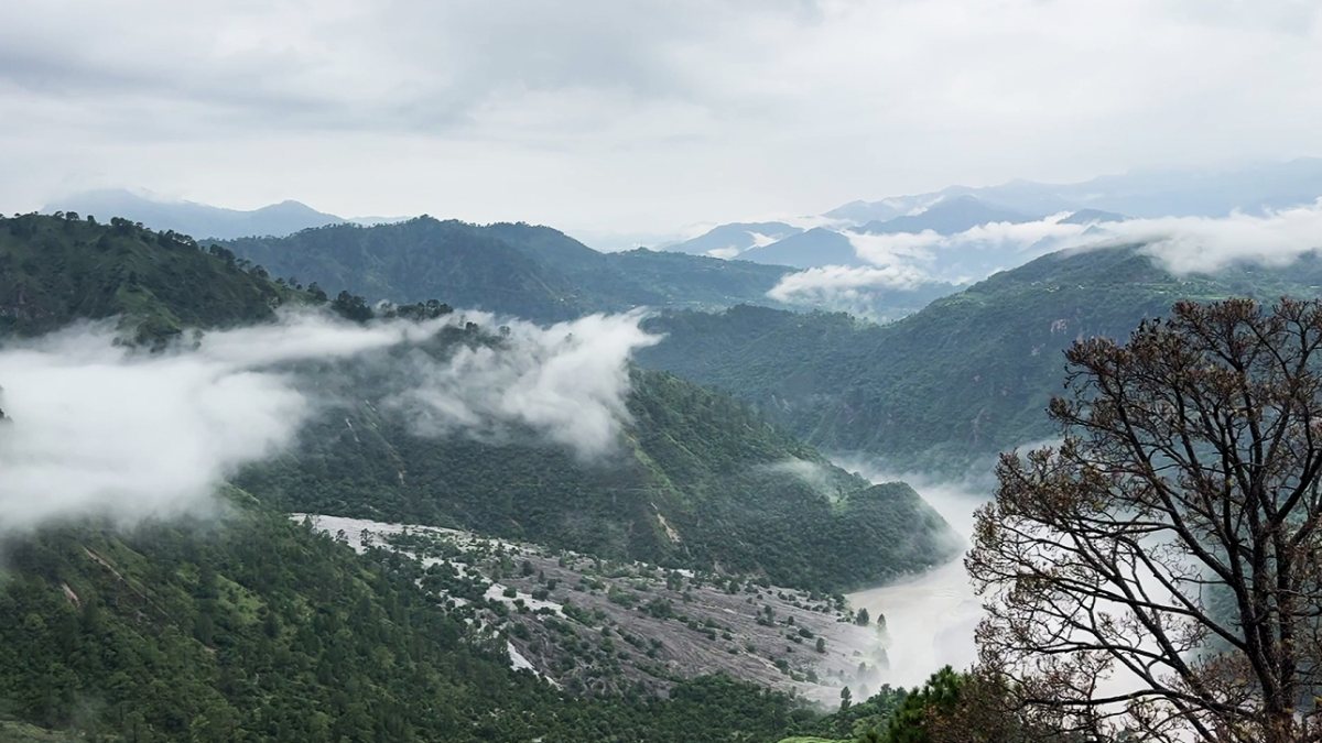 Cloudy skies over lush green valleys in Reasi