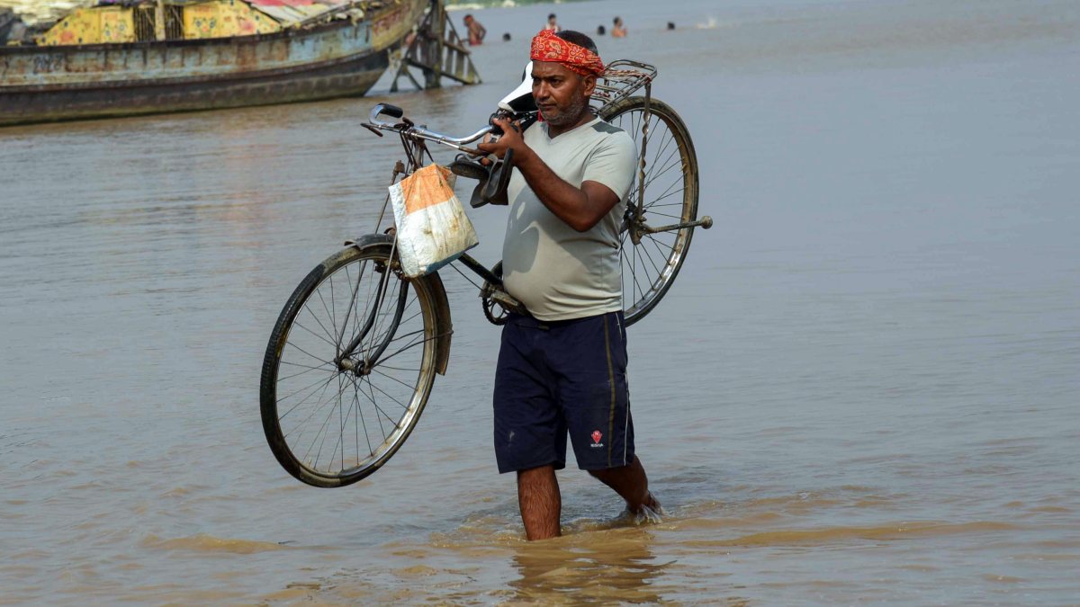 Patna residents wade through floodwaters after Ganga swells