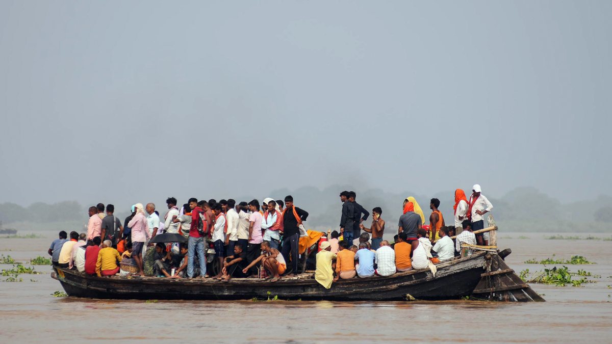 Bihar floods: Residents navigate Ganga waters by boat in Patna