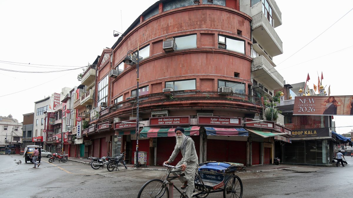 Rickshaw puller waits in empty market during Punjab Bandh in Amritsar